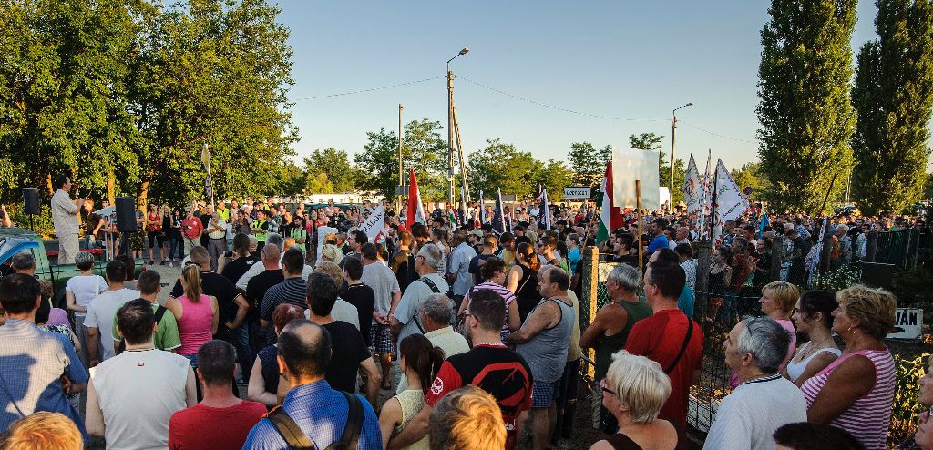 Debrecen, 2015. július 5. Résztvevõk hallgatják Apáti Istvánnak, a Jobbik alelnökének (b) beszédét a párt demonstrációján a Bevándorlási és Állampolgársági Hivatal debreceni befogadó állomásának közelében 2015. július 5-én. A Jobbik politikusai szerint azonnal zárttá kell tenni a debreceni menekülttábort és az ország többi, bevándorlókat befogadó állomását. MTI Fotó: Czeglédi Zsolt